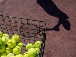 silhouette of a tennis player and tennis balls